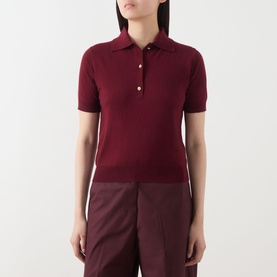 Model wearing Max Mara S red cotton silk cashmere polo knit top with short sleeves and gold buttons, styled with burgundy wide-leg trousers