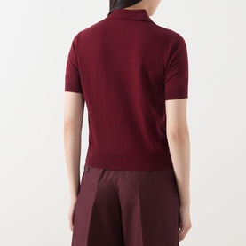 Model wearing Max Mara S red cotton-silk-cashmere knit polo top, short sleeves, rear view, styled with burgundy wide-leg trousers