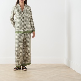 Model wearing Max Mara S Dice Silk Pyjama Shirt in Kaki Dice with matching wide-leg trousers, styled with brown sandals.
