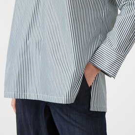 Model wearing Max Mara S Cristel Striped Shirt in dark green stripe cotton, with side slit hem detail, styled with navy trousers.