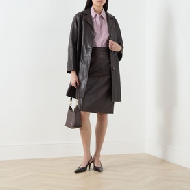 Model wearing Max Mara S Nebbie Striped Ruffle Sleeve Shirt in Bordeaux Small, styled with dark leather coat, skirt and heels.