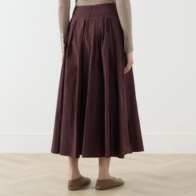 Model wearing Max Mara S Romina Flared Skirt in red, midi length with pleated waist and side pockets, styled with flat loafers