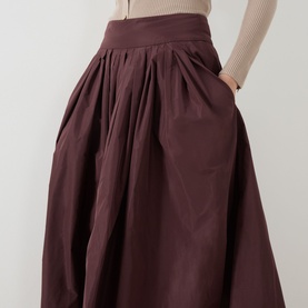 Model wearing Max Mara S Romina Flared Skirt in red, midi length with gathered waist and side pockets, styled with a beige knit top