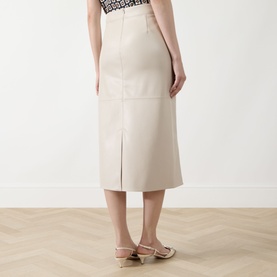 Model wearing Max Mara S beige cotton midi skirt, back view showing centre vent, styled with gold strappy flat sandals.
