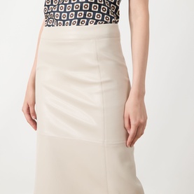 Model wearing Max Mara S beige leather-look midi skirt with panelled seam detail, styled with a geometric print top.