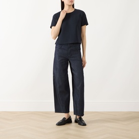 Model wearing Max Mara S ultramarine cotton T-shirt, styled with wide-leg dark trousers and black loafers.