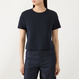 Model wearing Max Mara S ultramarine cotton blend cropped T-shirt with crew neck and short sleeves, styled with dark denim trousers.