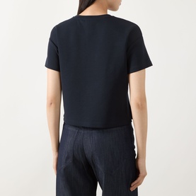 Model wearing Max Mara S ultramarine cotton blend T-shirt, rear view, styled with wide-leg trousers.