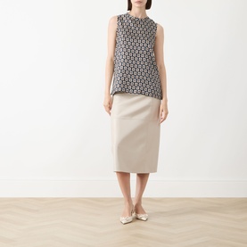 Model wearing Max Mara S Giornata Silk Printed Blouse in ultramarine geometric print, styled with a beige midi skirt and cream ballet flats.
