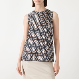Model wearing Max Mara S Giornata Silk Printed Blouse in ultramarine, sleeveless with crew neck and geometric square print, styled with cream trousers