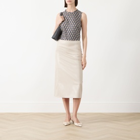 Model wearing Max Mara S Giornata Silk Printed Blouse in Ultramarine, sleeveless with crew neck, styled with cream midi skirt and flat shoes