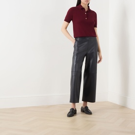 Model wearing Max Mara S Amati Coated Cropped Trousers in Ultramarine, straight-leg, mid-rise, styled with a burgundy polo shirt and black loafers
