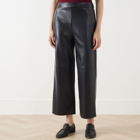 Model wearing Max Mara S Amati Coated Cropped Trousers in ultramarine, straight-leg style with covered waistband, styled with black loafers