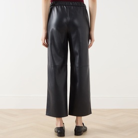 Model wearing Max Mara S Amati Coated Cropped Trousers in ultramarine, straight-leg silhouette with elasticated waist, styled with black loafers
