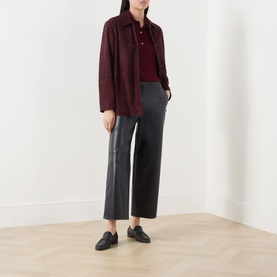 Model wearing Max Mara S Amati Coated Cropped Trousers in Ultramarine, straight-leg, styled with a burgundy shirt jacket and black loafers.