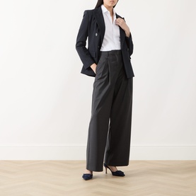 Model wearing Max Mara S Taro High-Waisted Wide Leg Trousers in dark grey wool, styled with a navy blazer, white shirt and navy heels.