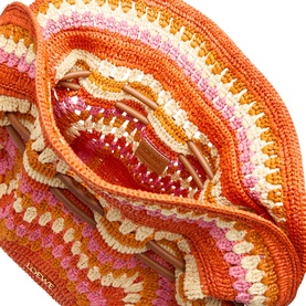 Loewe Flamenco Crochet Medium Clutch in bright orange and pink raffia, shown open to reveal red patent leather interior drawstring detail.