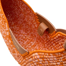 Loewe Swing Medium Shoulder Bag in bright orange and pink woven raffia, close-up interior showing tan leather trim and signature buckle embellishment.