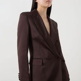 Model wearing Max Mara Studio chocolate blazer, featuring a deep V-neck, peak lapels, and button-cuff sleeves