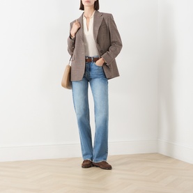 Model wearing Max Mara Studio navy various wool blazer, styled with cream blouse, light blue straight-leg jeans and brown loafers