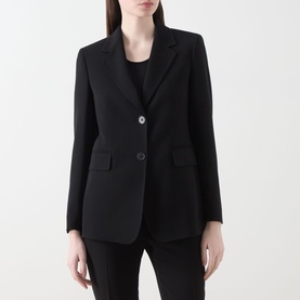 Model wearing Max Mara Studio black blazer, two-button front, notch lapel, flap pockets, styled with black trousers