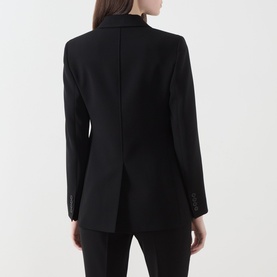 Model wearing Max Mara Studio black blazer, rear view, tailored fit with centre vent, styled with black trousers