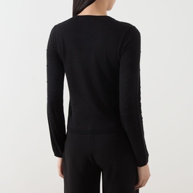 Model wearing Max Mara Studio black silk-wool cardigan, back view, styled with black trousers