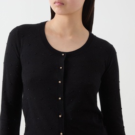 Model wearing Max Mara Studio black silk-wool cardigan with scattered embellishments and gold-tone buttons, close-up detail view.