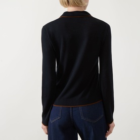 Model wearing Max Mara Studio Targa Knit Cardigan in ultramarine with contrast trim detail, rear view, styled with dark denim jeans