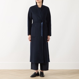 Model wearing Max Mara Studio navy bicolour wool coat with belt tie, styled with wide-leg trousers and black loafers.