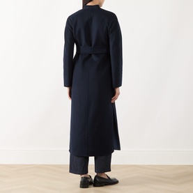 Model wearing Max Mara Studio navy bicolour wool coat, back view, belted waist, with dark trousers and black loafers