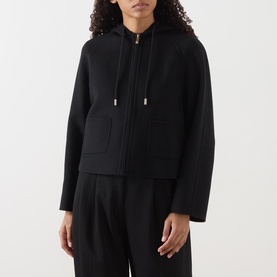 Model wearing Max Mara Studio black wool-silk-cashmere hooded zip jacket with drawstring detail, styled with matching black wide-leg trousers