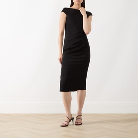 Model wearing Max Mara Studio black midi dress with off-shoulder neckline and ruched body-con silhouette, styled with black strappy heels.