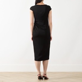 Model wearing Max Mara Studio black cap-sleeve midi dress, rear view, styled with black mule heels