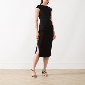 Model wearing Max Mara Studio black midi dress with asymmetric neckline, cap sleeves, ruched side detail and front split, styled with black heeled