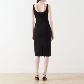 Model wearing Max Mara Studio Sala Sweetheart Dress in black technical cady, midi length, rear vent visible, styled with brown heeled sandals.