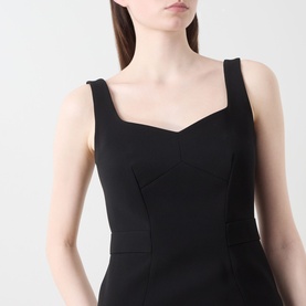 Model wearing Max Mara Studio Sala Sweetheart Dress in black, showing sweetheart neckline and wide straps in technical cady fabric.