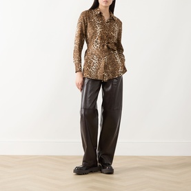 Model wearing Max Mara Studio Brown Spotted silk jacket with leopard print and self-tie belt, styled with dark leather trousers and black loafers.