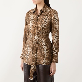 Model wearing Max Mara Studio Brown Spotted silk jacket with leopard print, belted waist, and shirt collar, styled with dark leather trousers