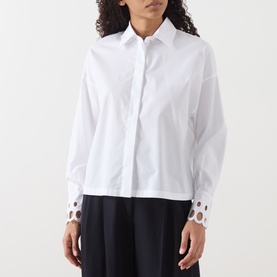 Model wearing Max Mara Studio Staffa Broderie Anglaise Shirt in Optical White with embroidered cuffs, styled with black wide-leg trousers.