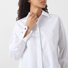 Model wearing Max Mara Studio Staffa Broderie Anglaise Shirt in Optical White, close-up detail of embroidered cuffs and concealed button fastening