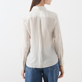 Model wearing Max Mara Studio silk shirt in natural stripe, shown from the back, styled with blue jeans. Long sleeves, relaxed fit.