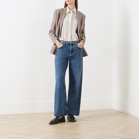 Model wearing Max Mara Studio Natural Stripe silk shirt, styled with a taupe blazer, wide-leg blue jeans and black loafers.