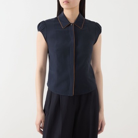 Model wearing Max Mara Studio Midnight Blue silk shirt with contrast trim, cap sleeves and zip front, styled with black skirt.