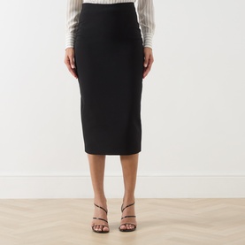Model wearing Max Mara Studio black midi pencil skirt with high waist, styled with strappy heeled sandals and white top.