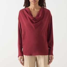 Model wearing Max Mara Studio ruby cowl neck long sleeve top, styled with beige trousers
