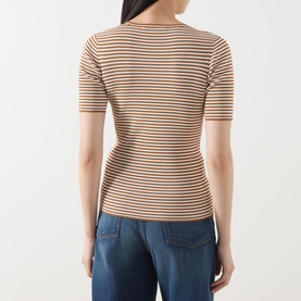 Model wearing Max Mara Studio caramel white striped short-sleeve knit top, back view, styled with blue jeans