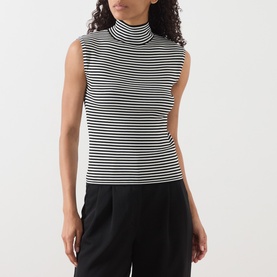 Model wearing Max Mara Studio black and white striped sleeveless roll-neck top, styled with black wide-leg trousers