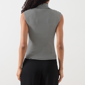 Model wearing Max Mara Studio black and white stripe sleeveless polo neck top, back view, styled with black wide-leg trousers.