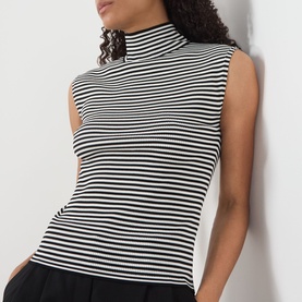 Model wearing Max Mara Studio black and white stripe sleeveless mock-neck top in fitted ribbed fabric.